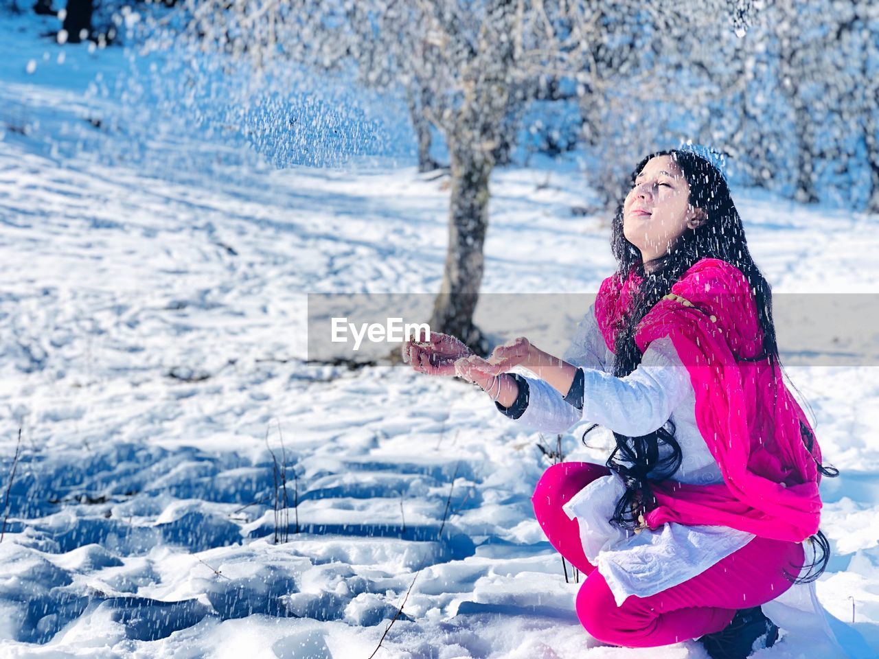 Young woman enjoying snowfall