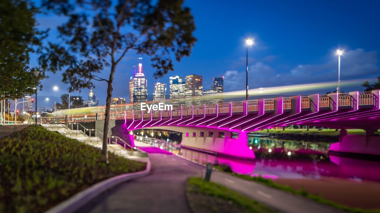Bridge over illuminated city at night