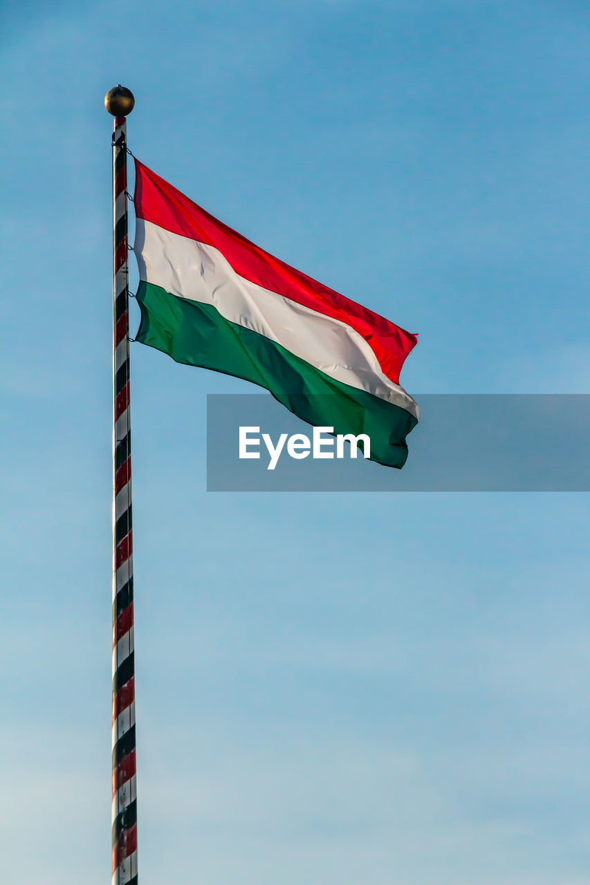 Low angle view of hungarian flag against sky
