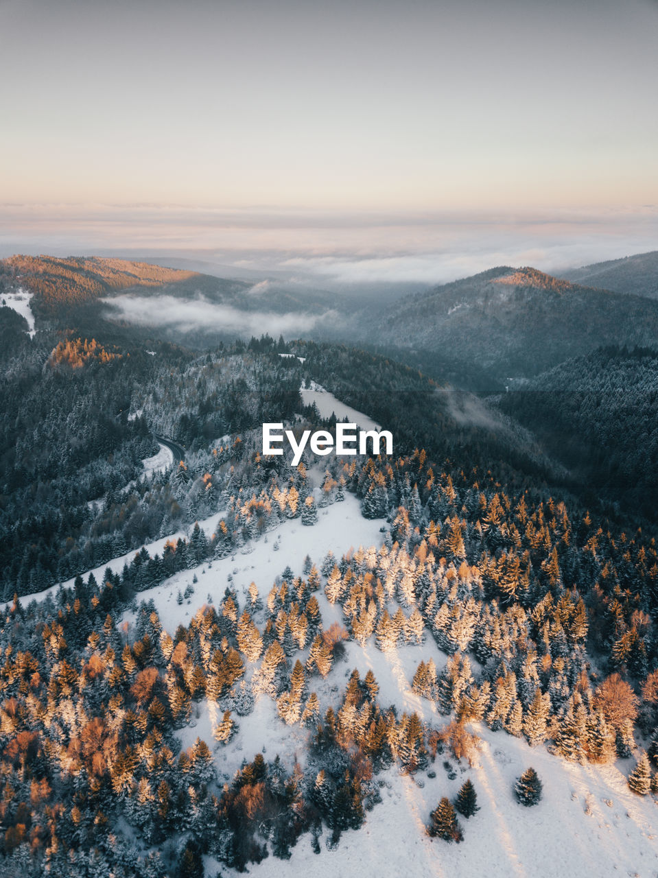 Moody aerial drone idyllic winter landscape at sunrise. wiew from the top of the mountains.