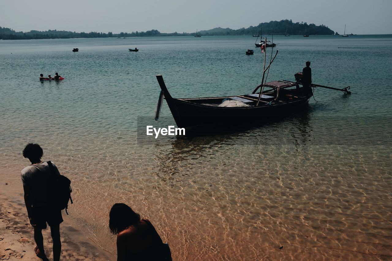 People at beach at dusk