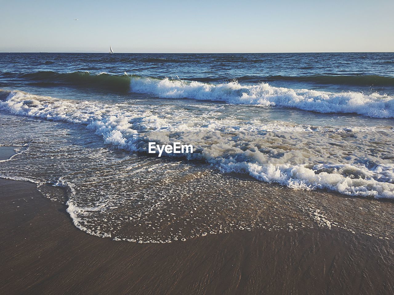 Scenic view of beach against clear sky