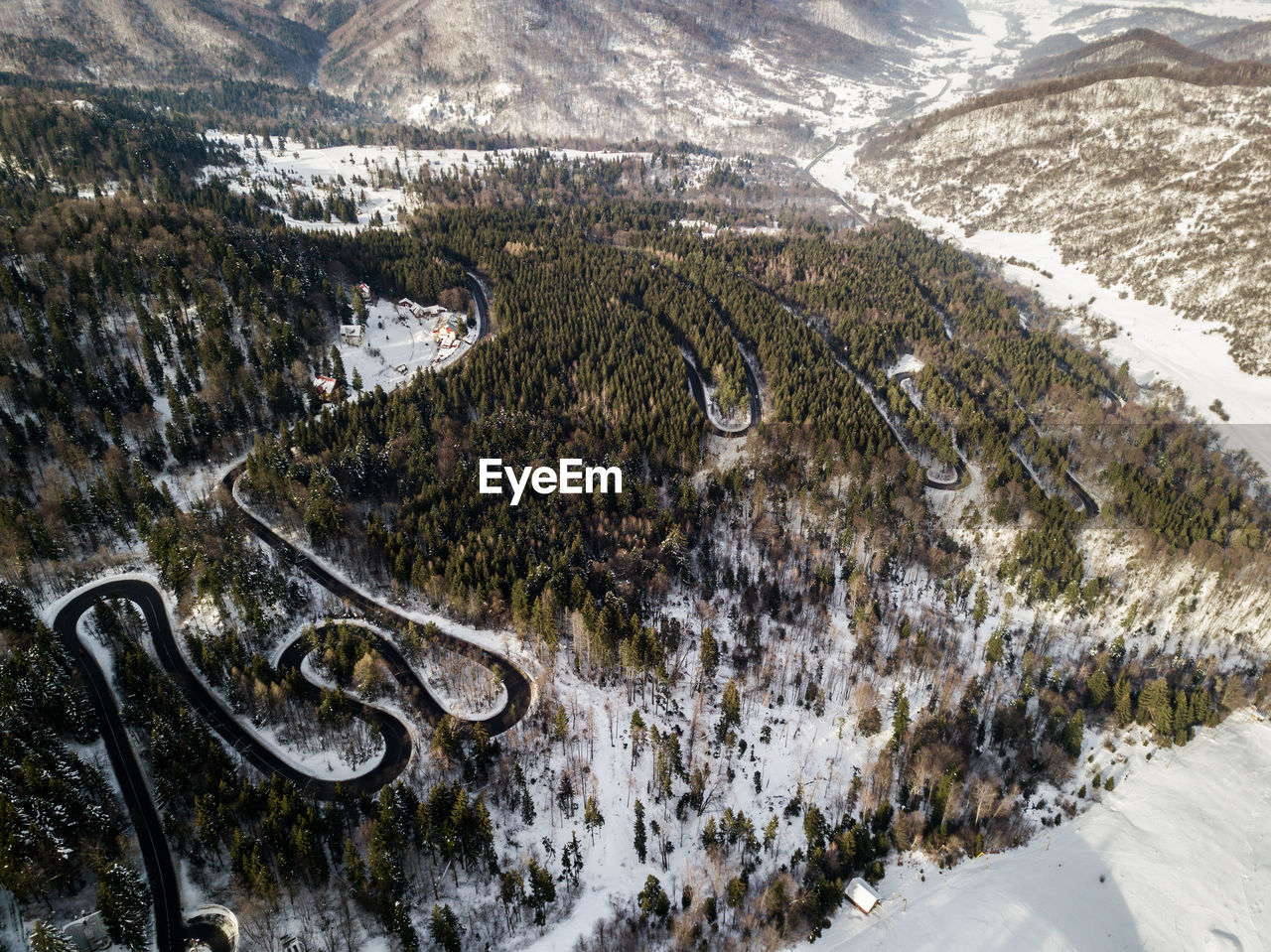 HIGH ANGLE VIEW OF SNOW COVERED ROAD