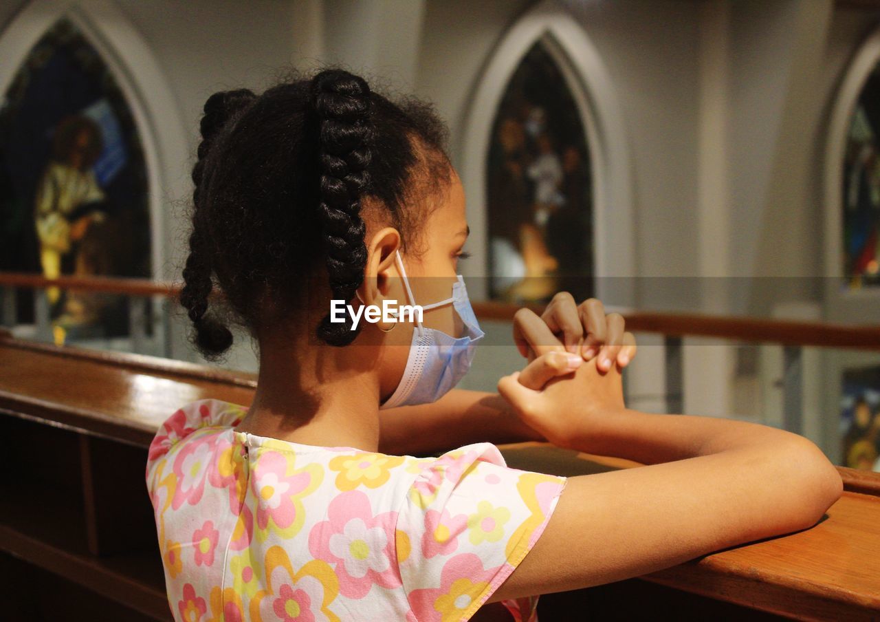 A girl is praying in the church