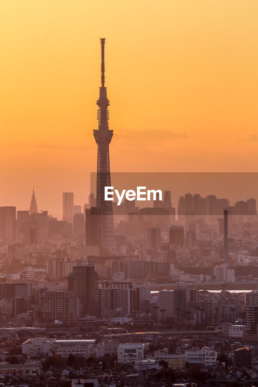 View of buildings in city during sunset