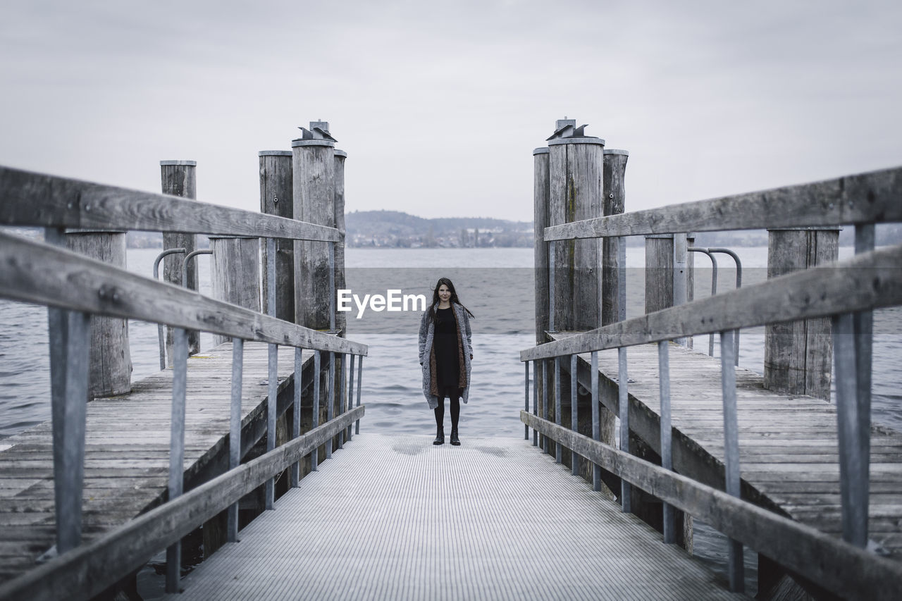 Woman standing on pier