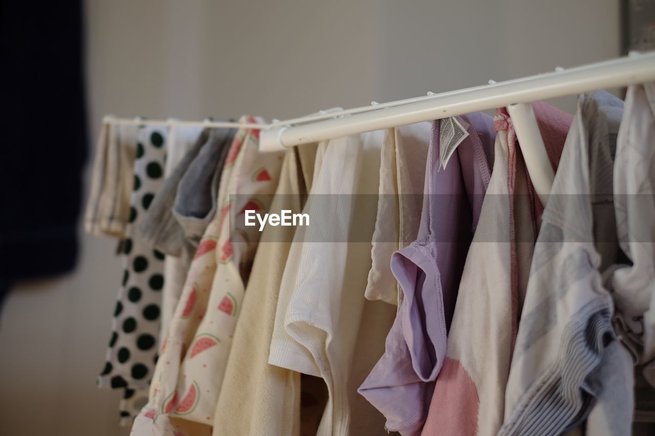 CLOSE-UP OF CLOTHES DRYING IN RACK