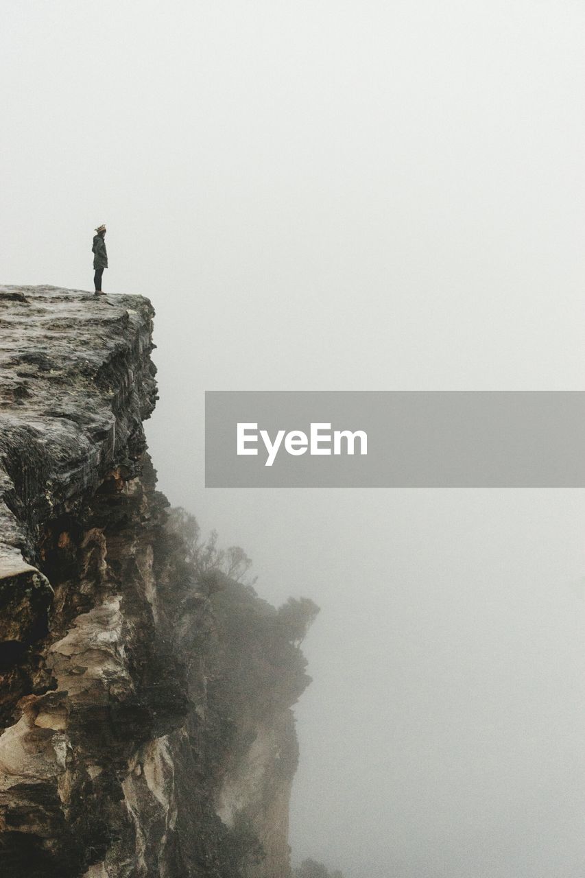 Woman standing on cliff