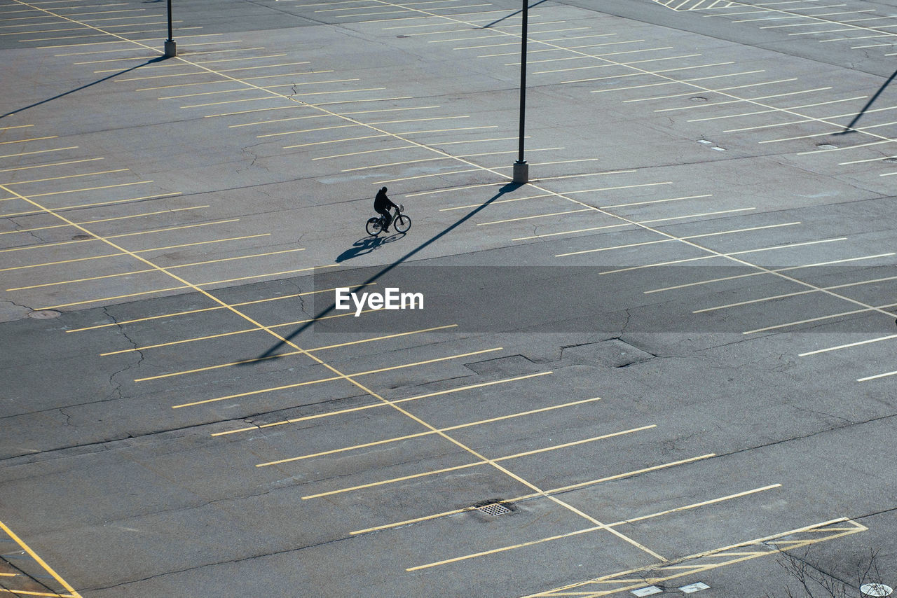 High angle view of man riding bicycle on road