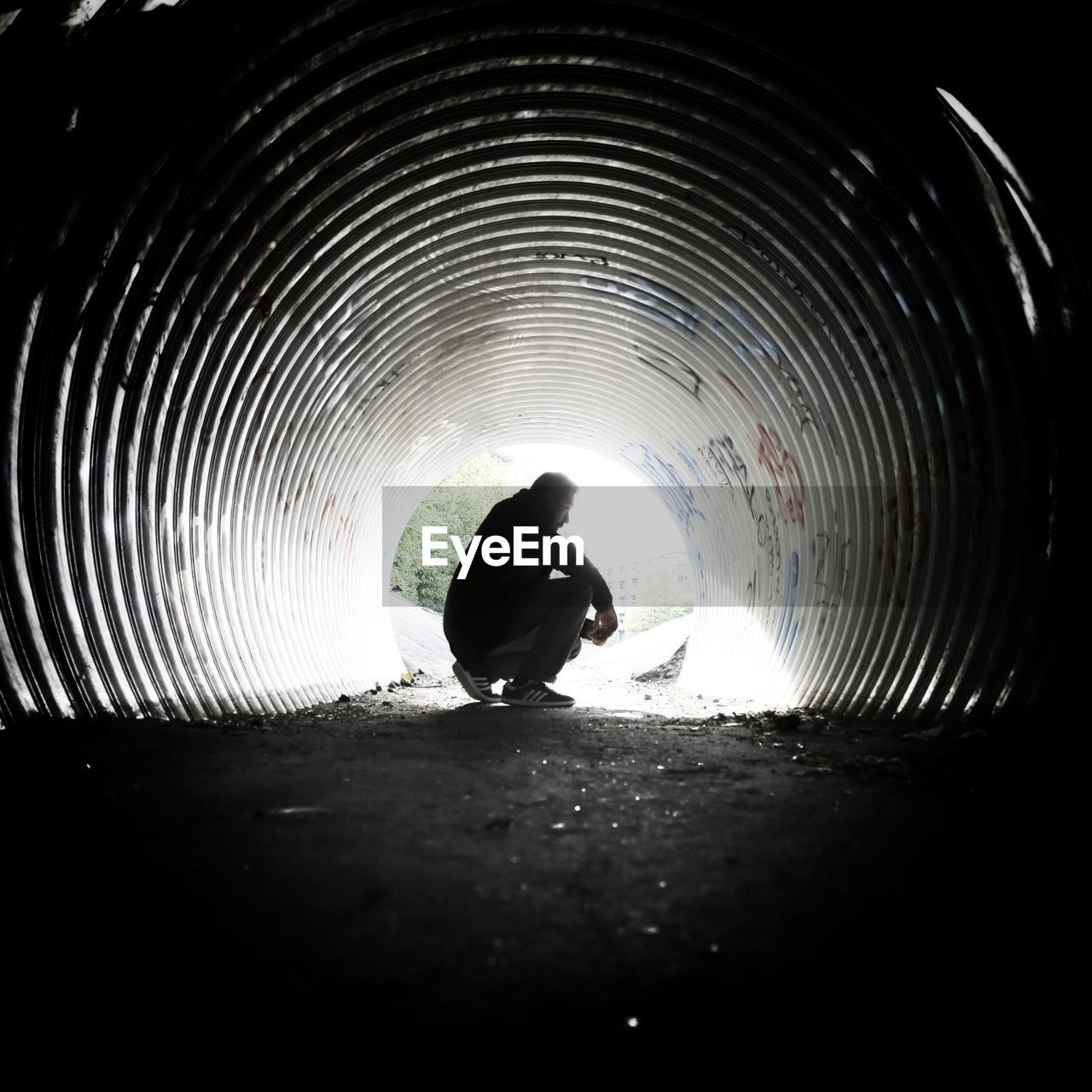 WOMAN WALKING IN TUNNEL