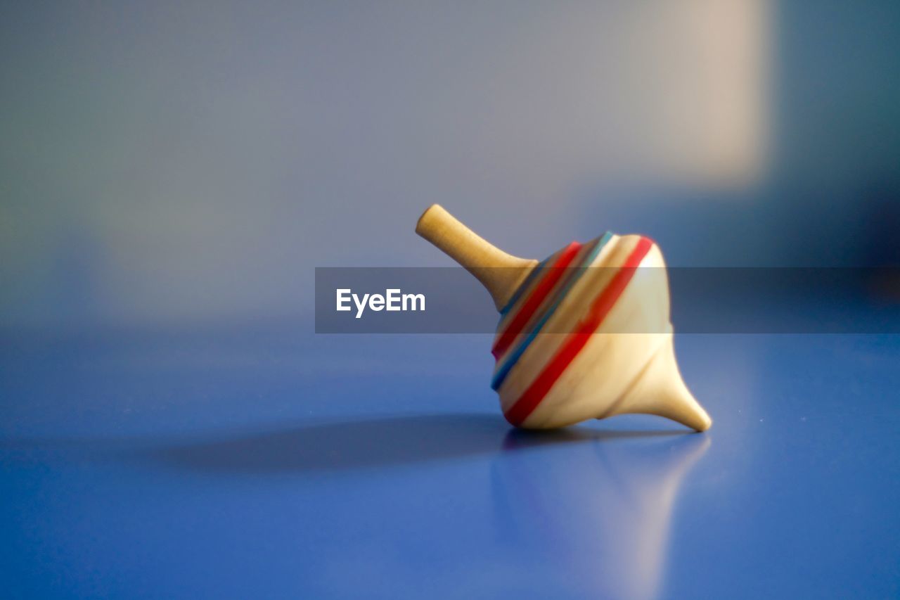 Close-up of colorful wooden spinning top on table