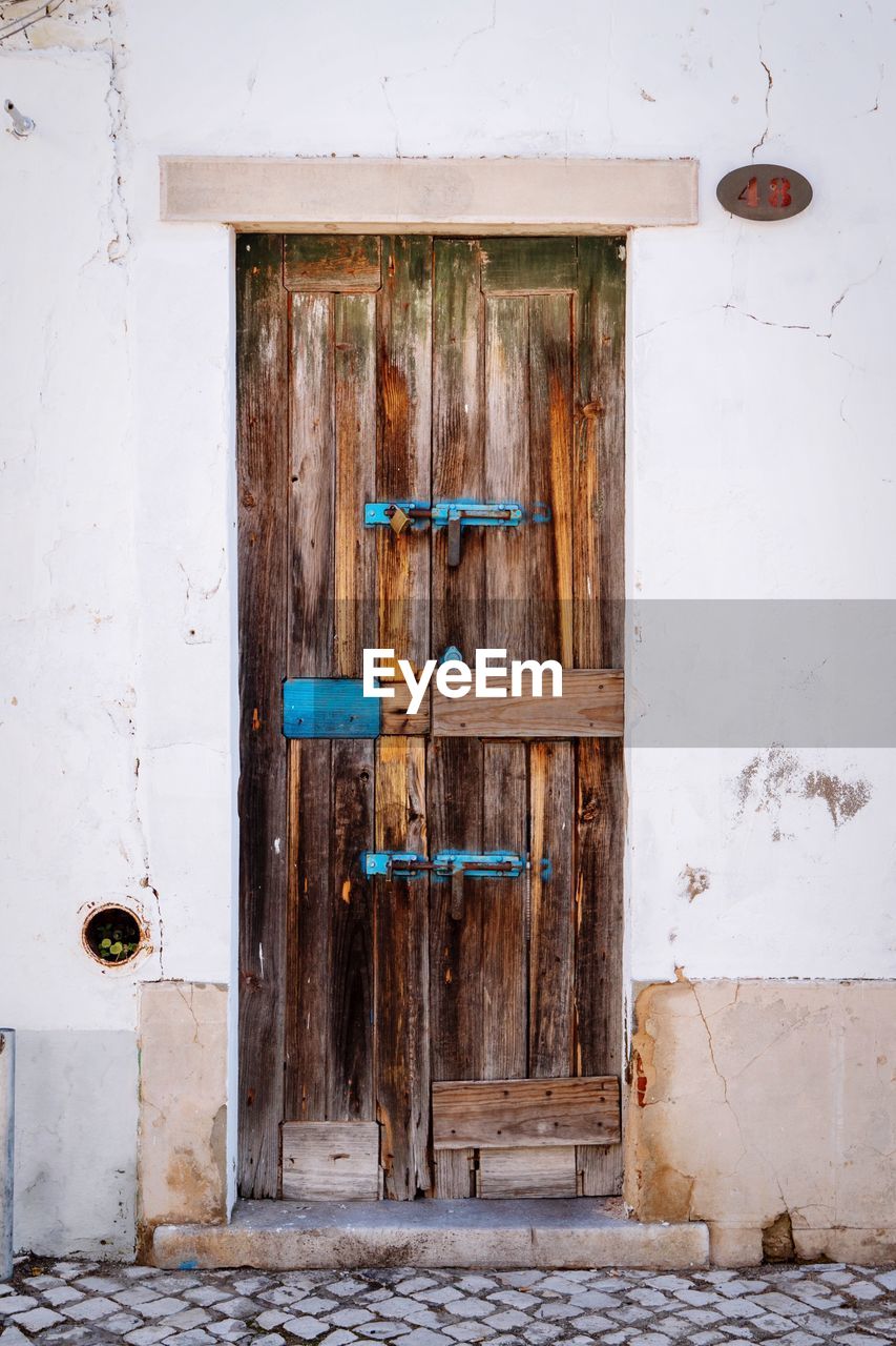 Closed wooden door of old building