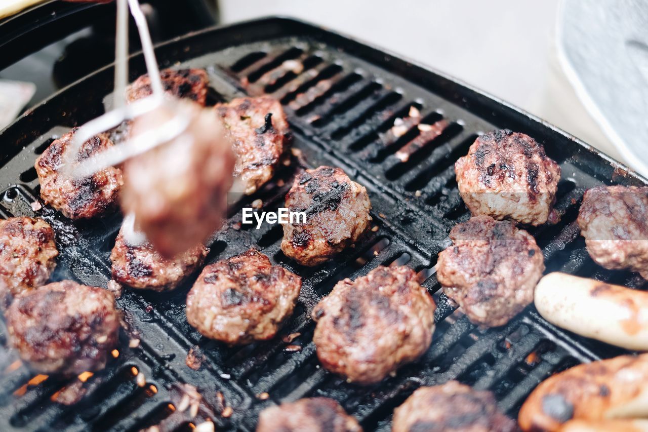 High angle view of meat on barbeque grill