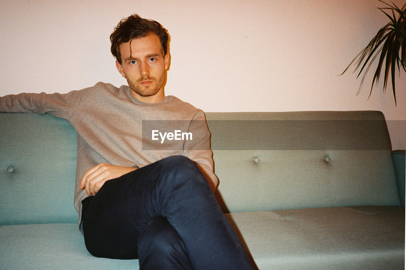 Portrait Of Man Sitting On Couch Id 102653031