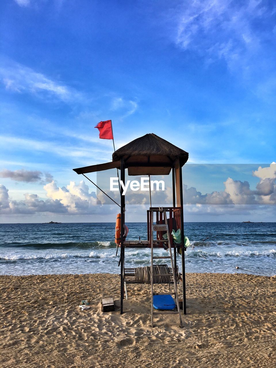 Lifeguard hut on beach against sky