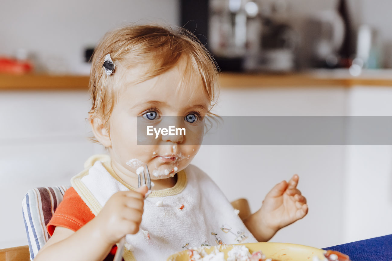 Cute Girl Eating Food At Home Id 126780339