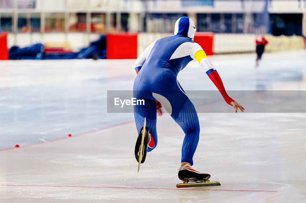 Full length of man ice skating on rink