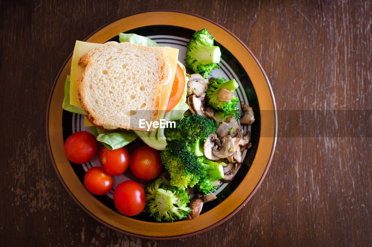 High angle view of bread and vegetables in plate