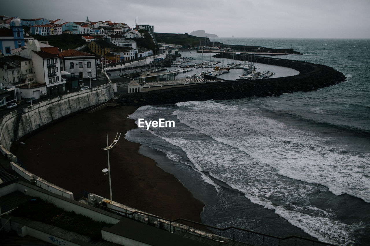High angle shot of buildings by calm sea