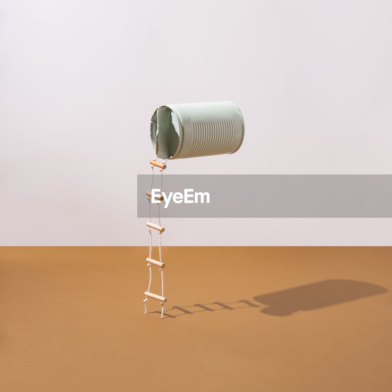 Pastel blue can with attached ladders. minimalist concept. square layout