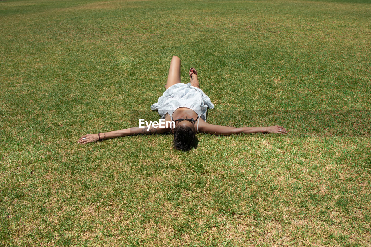 Full length of woman lying on grass