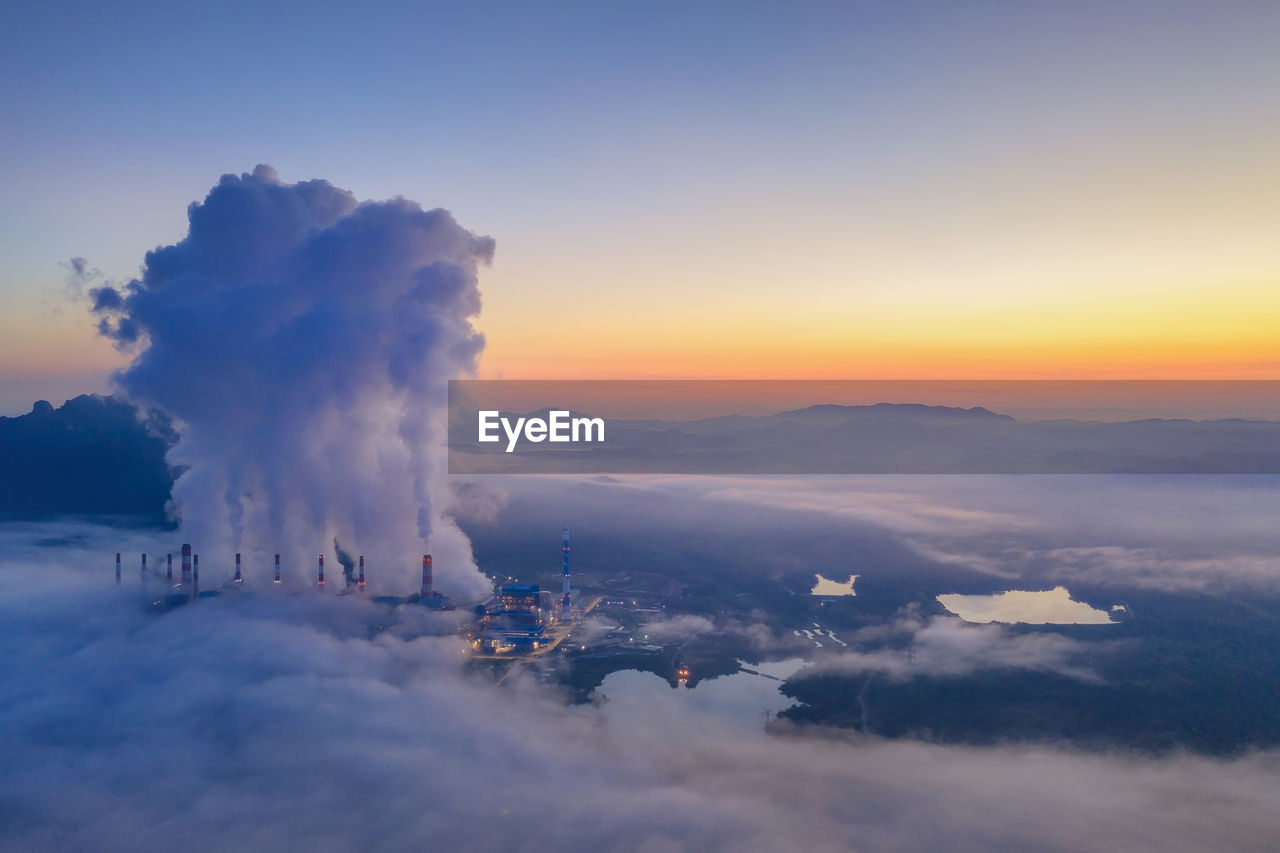 Aerial view of clouds over mountains during sunset coal power plant