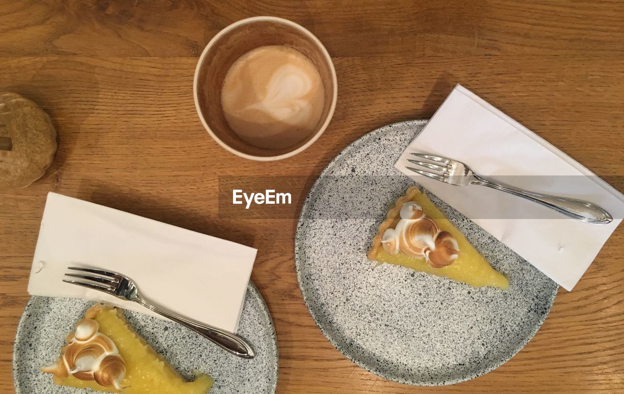HIGH ANGLE VIEW OF COFFEE CUP WITH TEXT ON TABLE