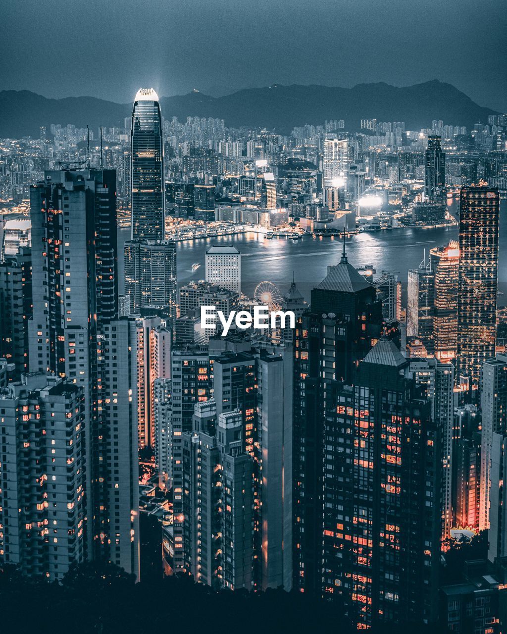 High angle view of illuminated city buildings against sky