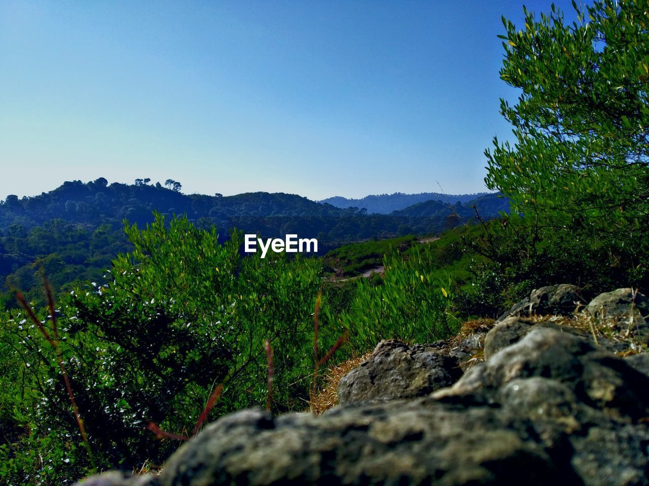 Scenic view of mountains against clear blue sky
