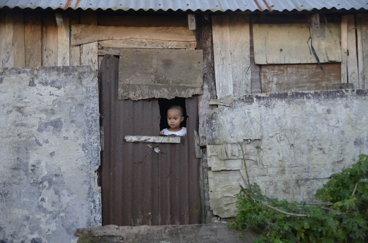 Boy Looking Through Door Window On Eyeem