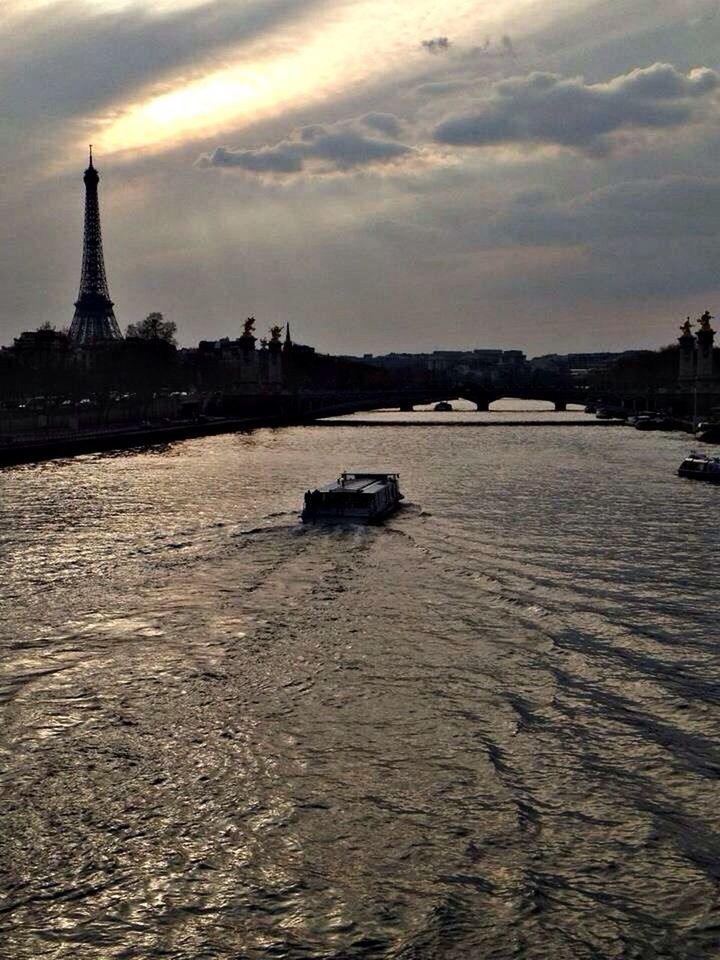 Cruise boat sailing on river seine by eiffel tower