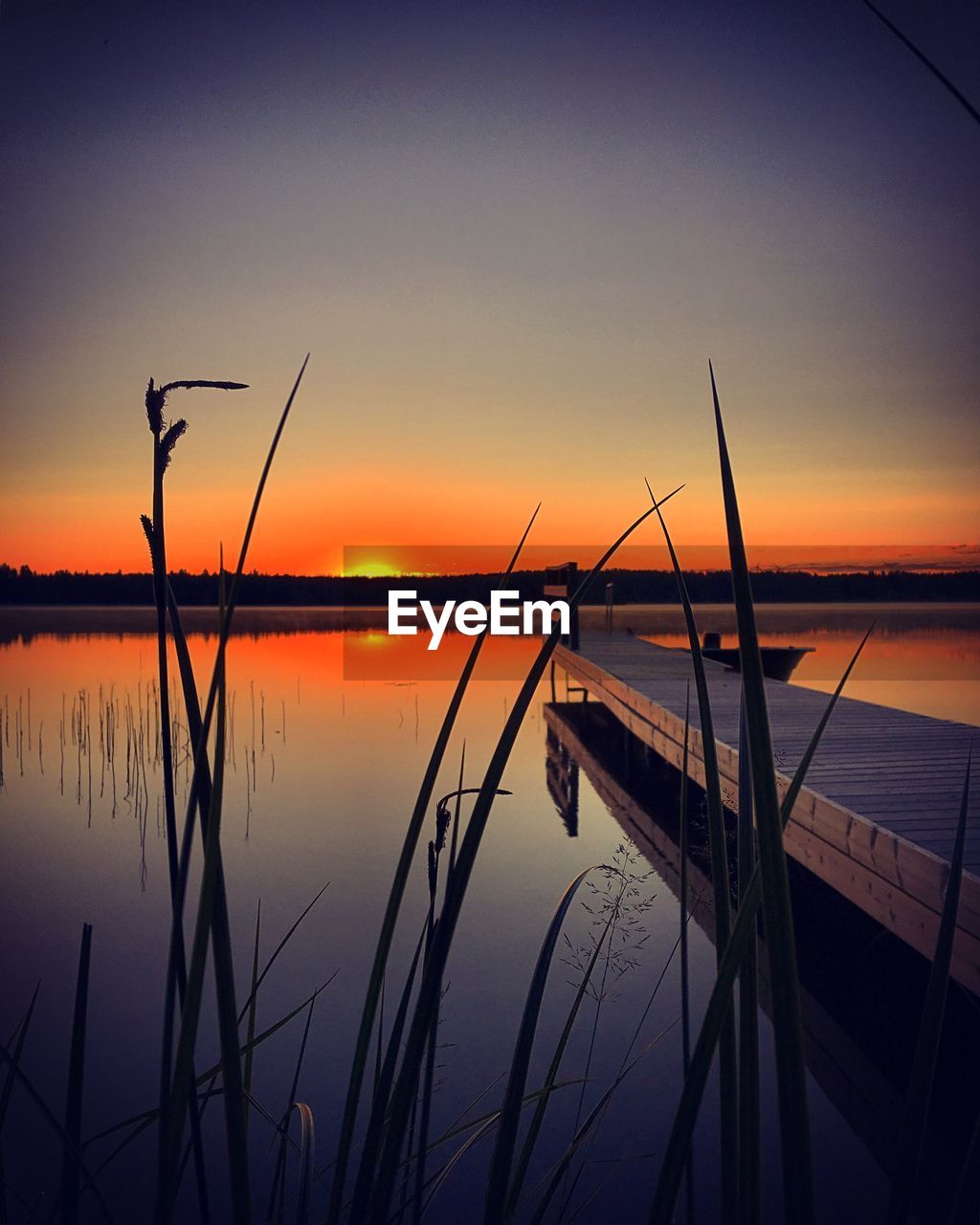 Scenic view of lake against sky during sunrise