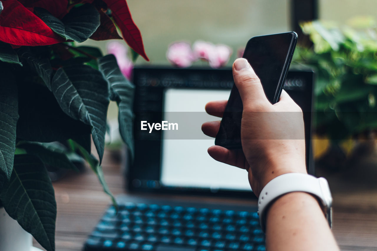 Using technology at home/holding a smartphone