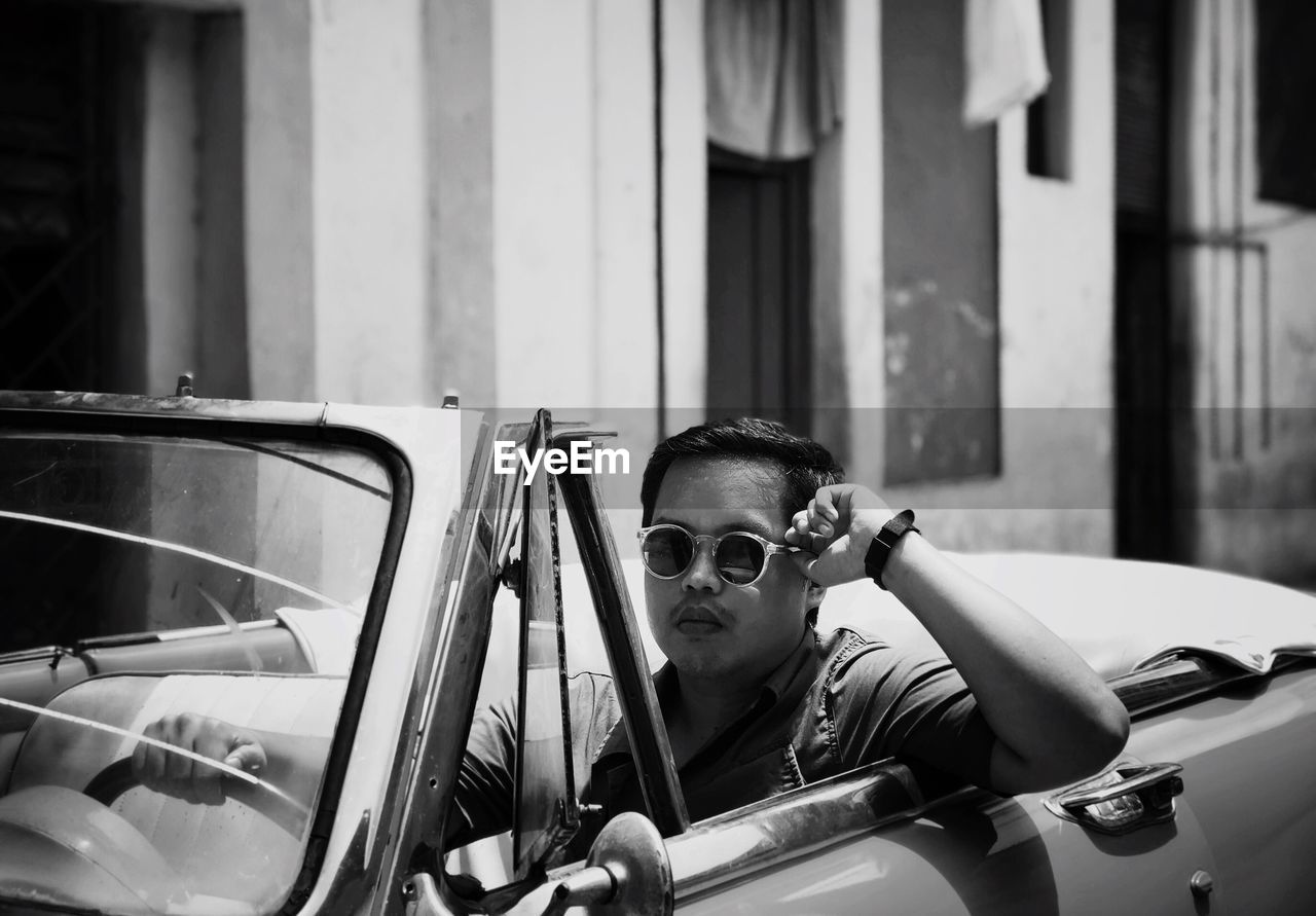 Portrait of man sitting in car