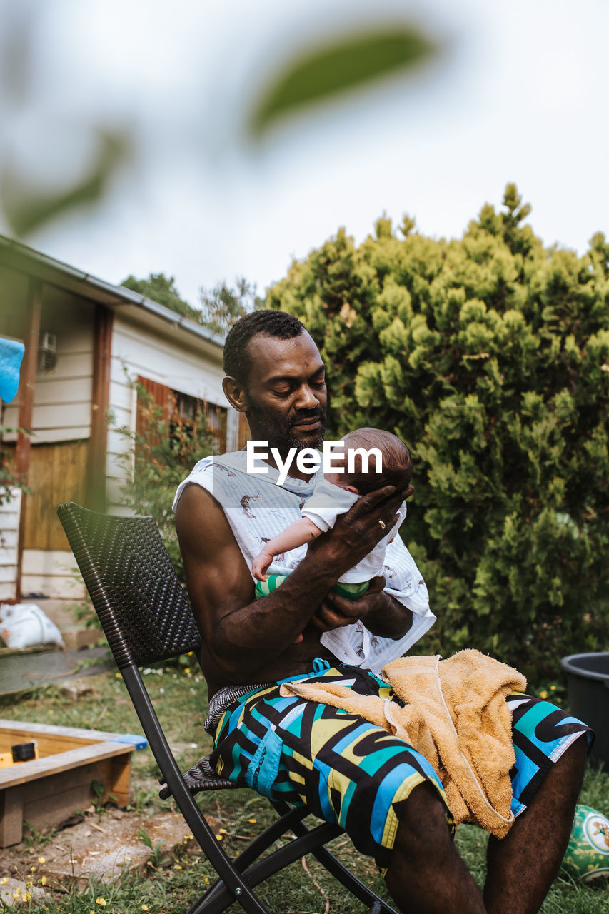 Black father holding his newborn son