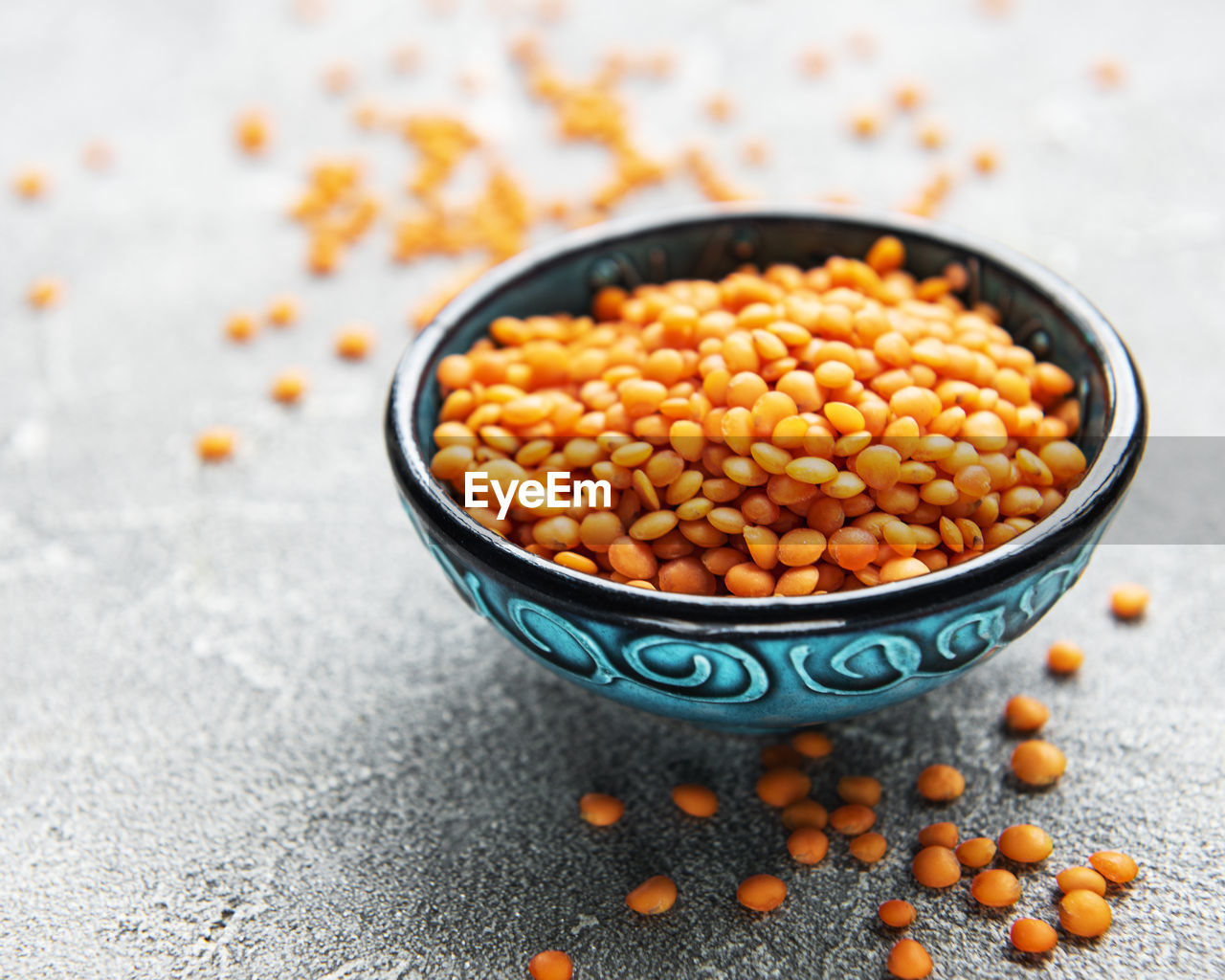Organic healthy red lentils in bowl on a table