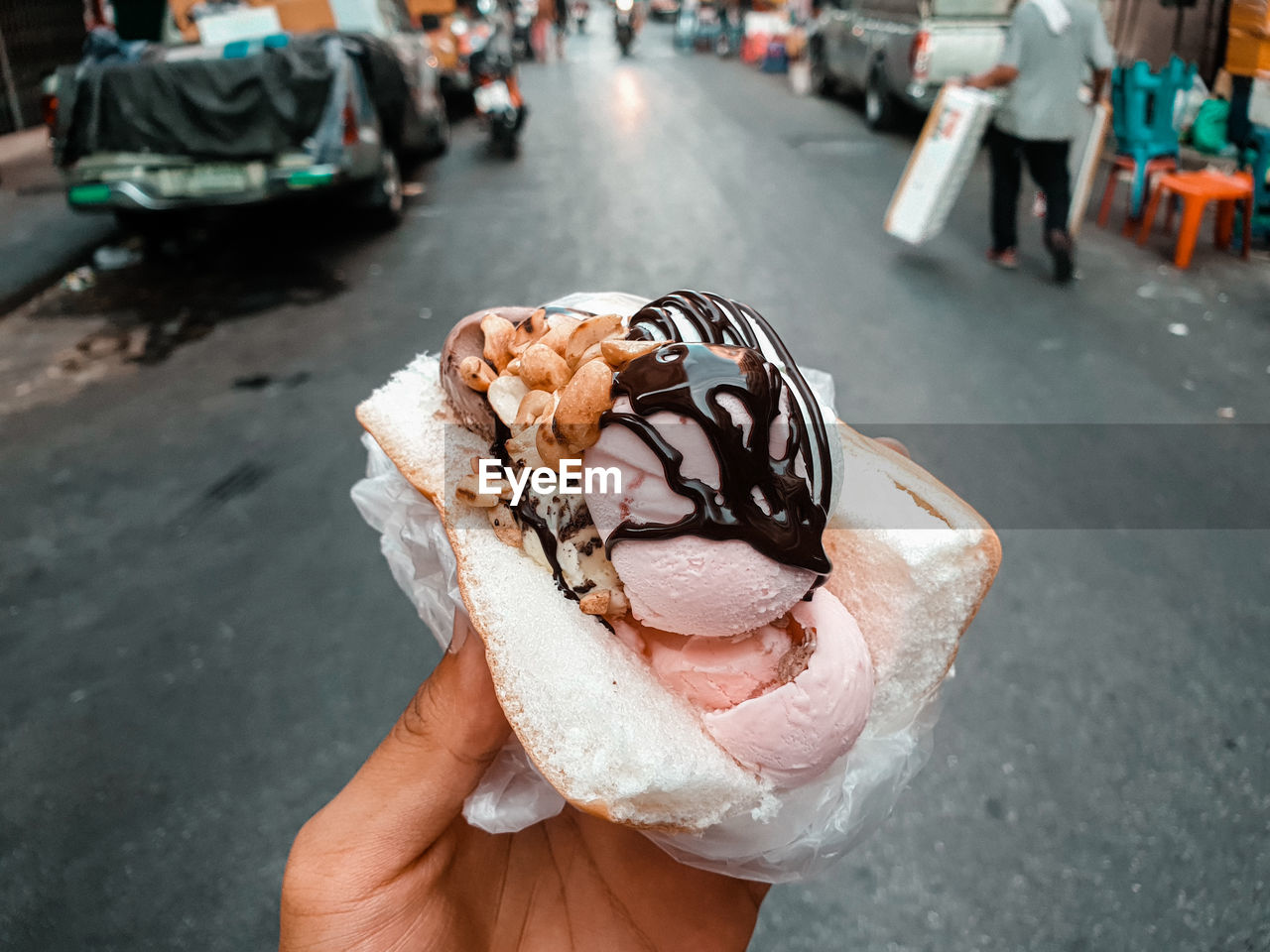 Midsection of ice cream on street