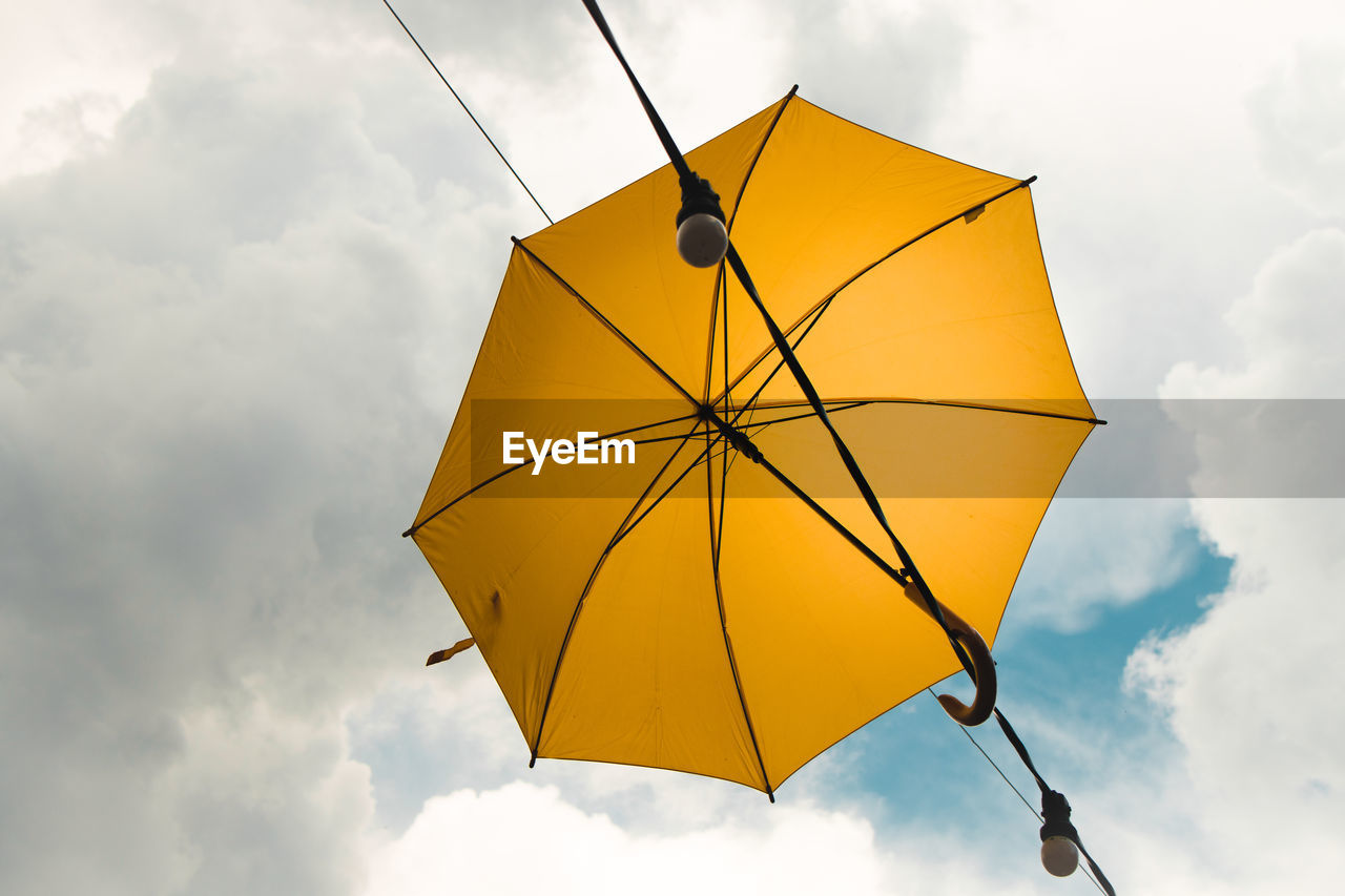 LOW ANGLE VIEW OF UMBRELLA AGAINST SKY