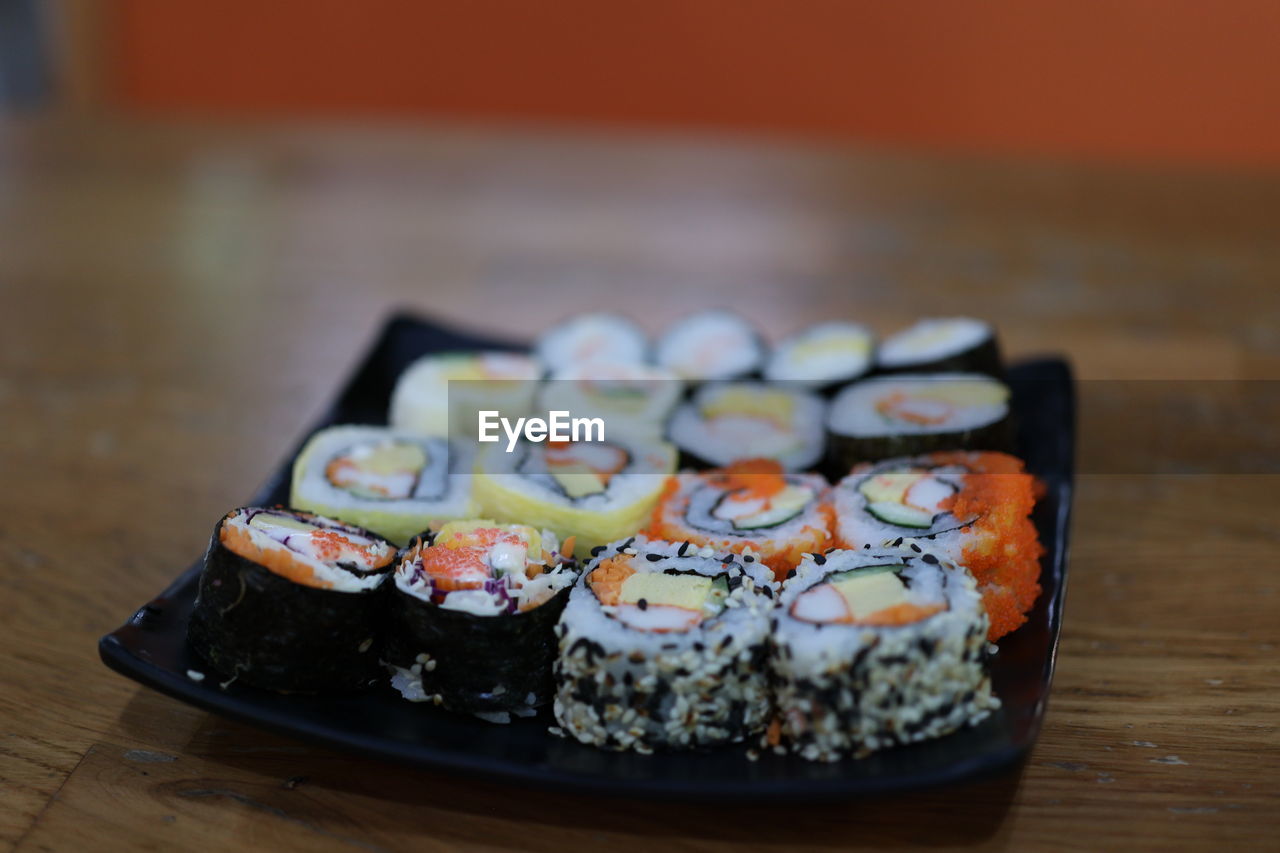 CLOSE-UP OF SUSHI IN TRAY ON TABLE