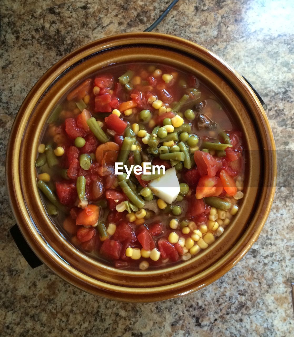 Close-up of vegetables in crock pot served on table