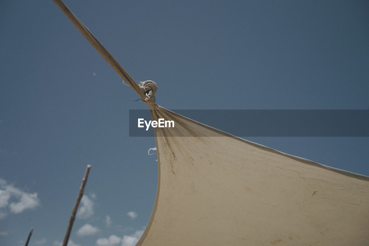 sky, wind, nature, blue, no people, day, low angle view, mast, environment, outdoors, line, renewable energy, architecture, cloud