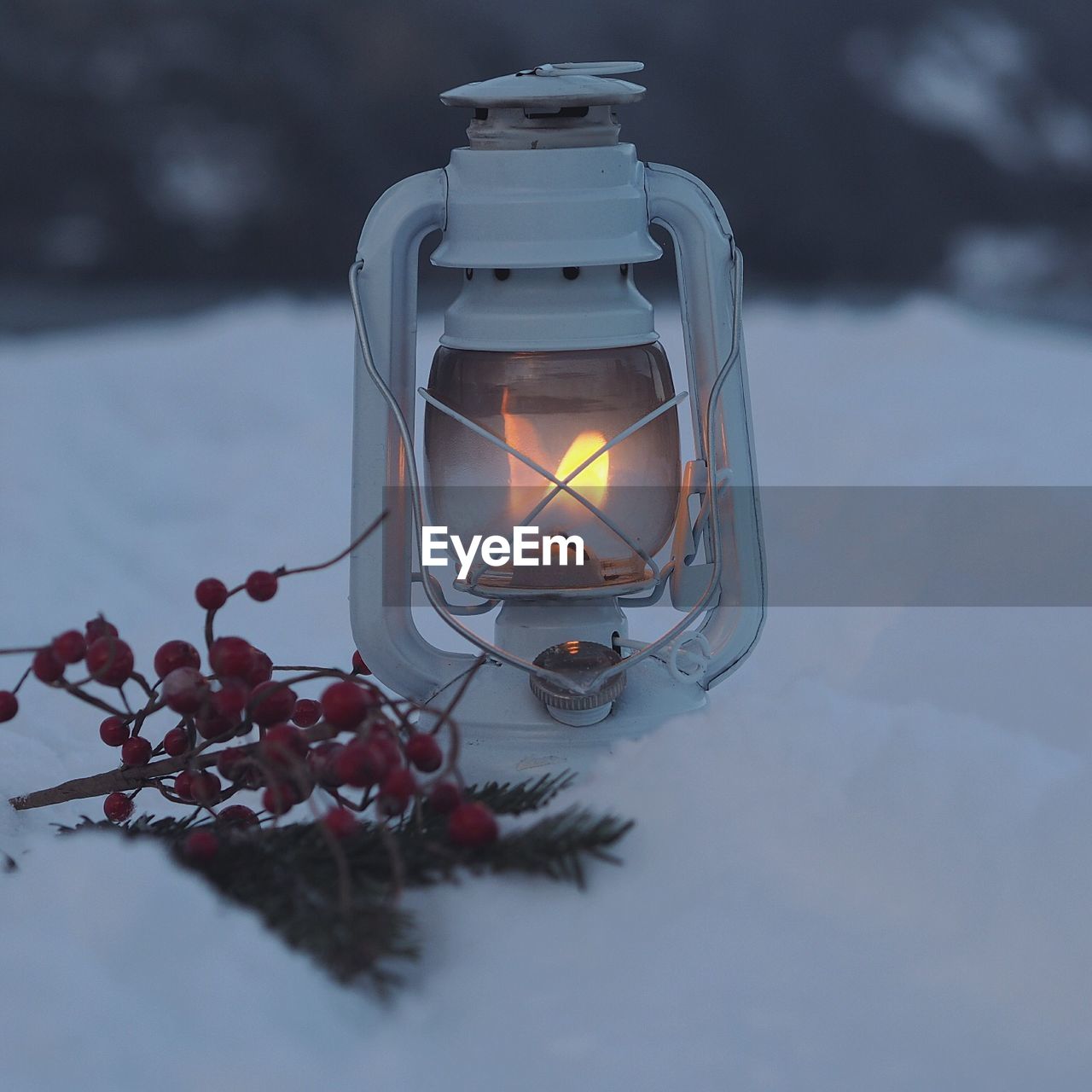 Close-up of illuminated lantern on snow during winter