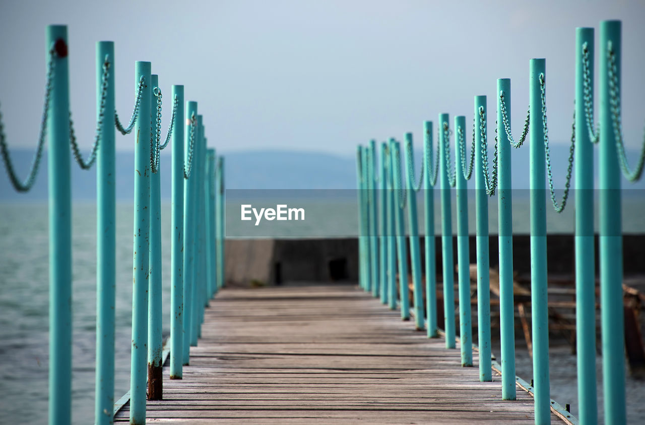 Close-up of wooden jetty at beach against sky