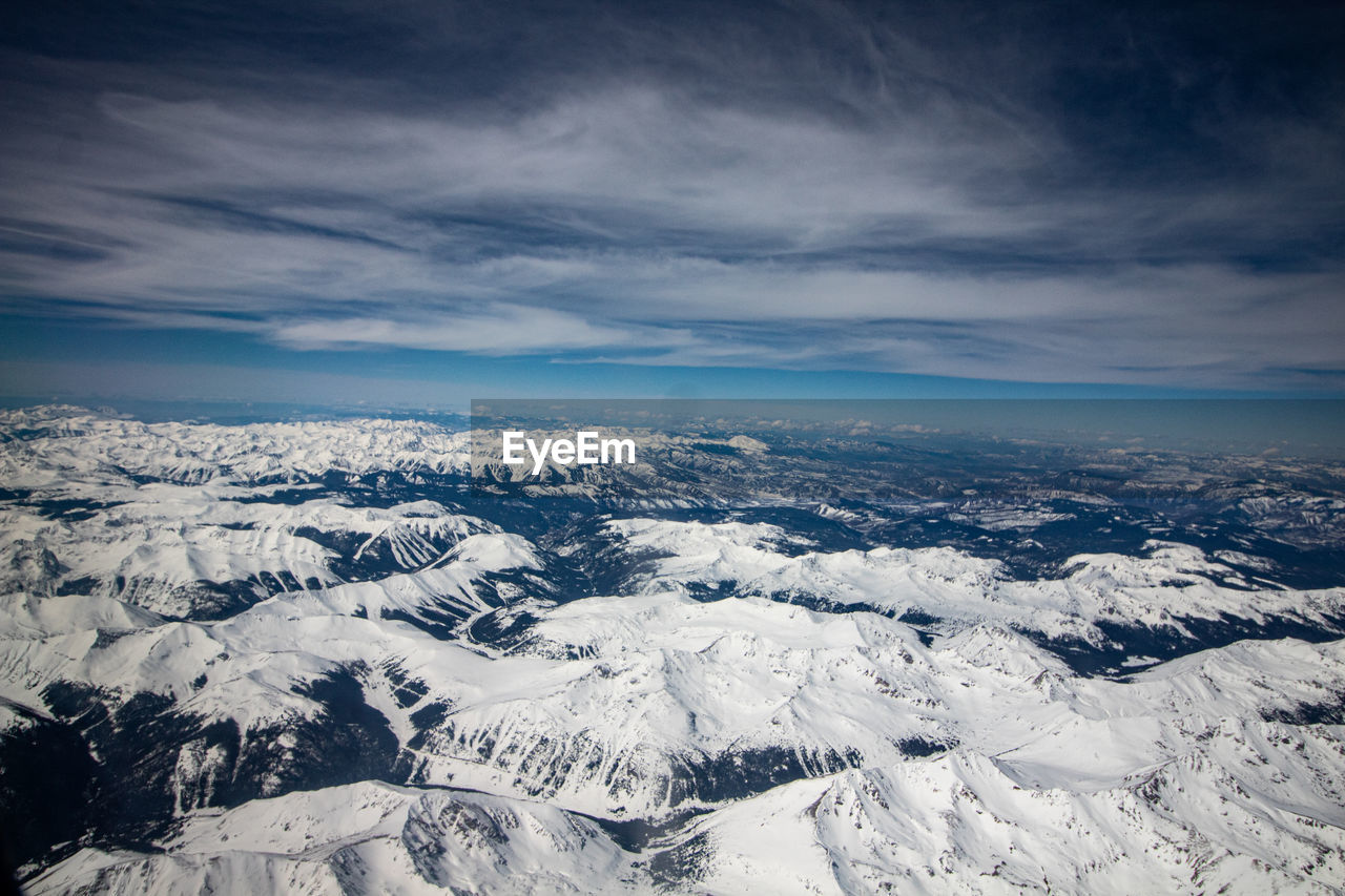 SCENIC VIEW OF SNOWCAPPED MOUNTAINS AGAINST SKY DURING WINTER