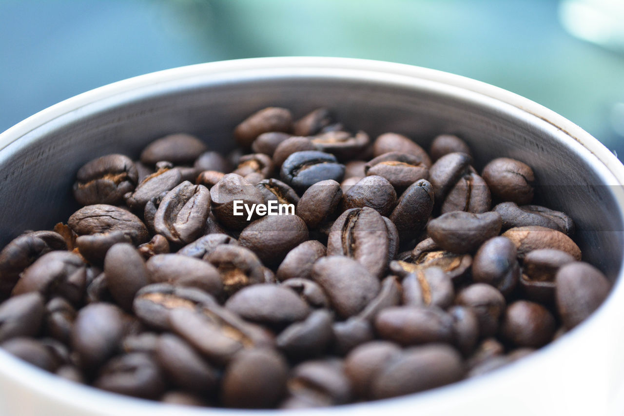 High angle view of roasted coffee beans in bowl