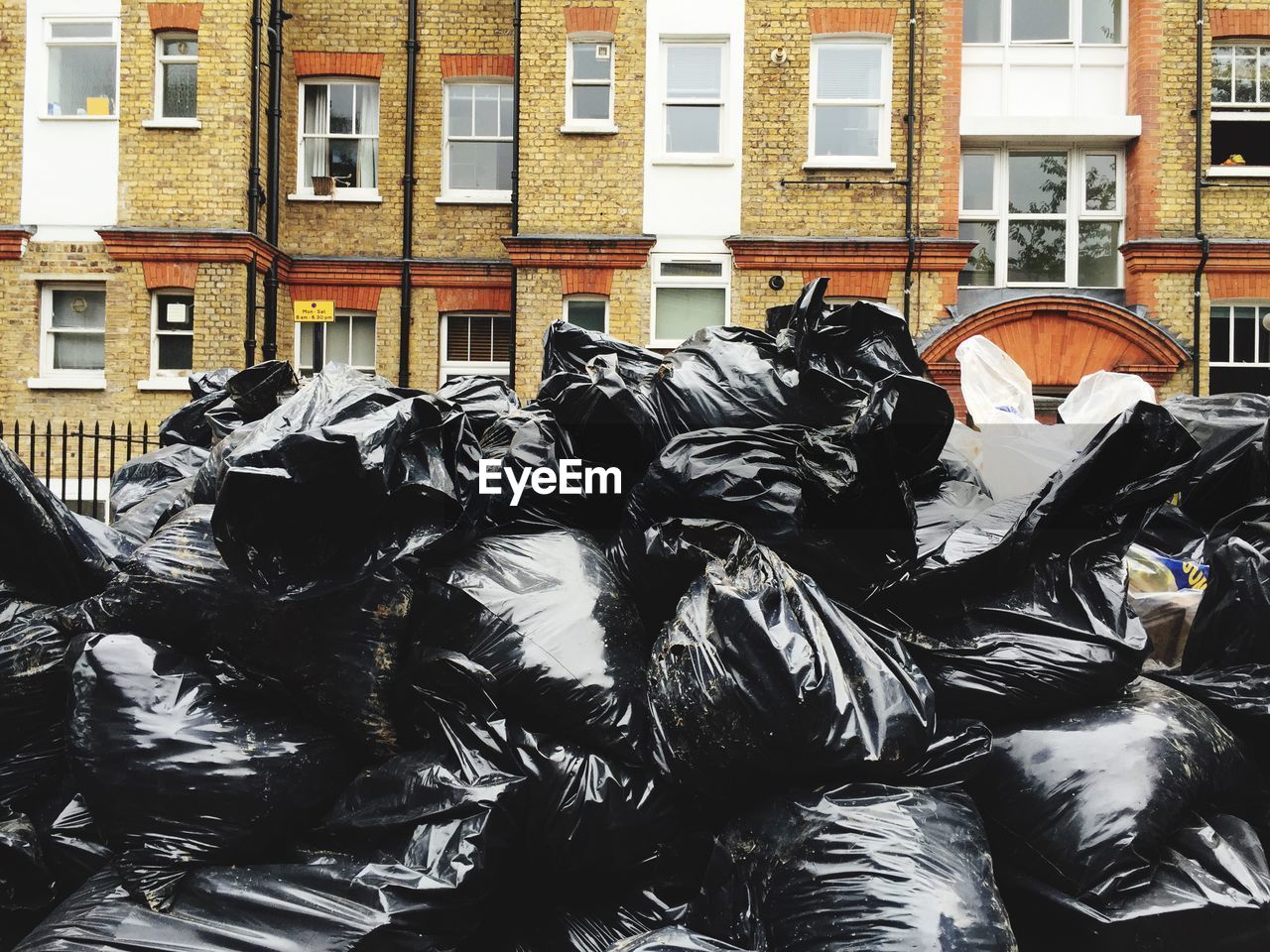 Garbage in bags against building in city