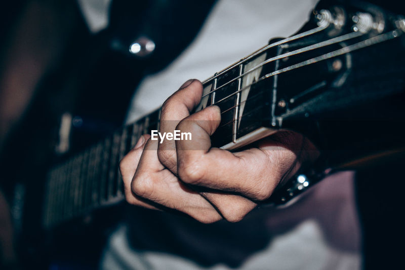 Close Up Of Person Playing Guitar Id