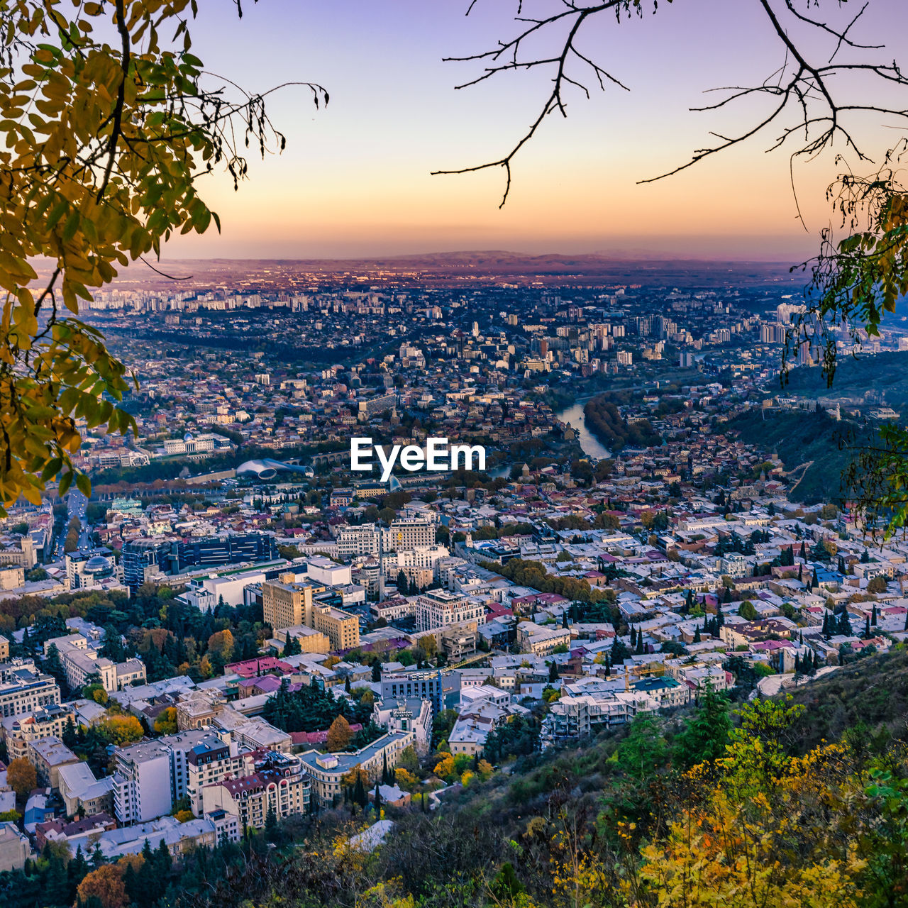 HIGH ANGLE SHOT OF TOWNSCAPE AGAINST SKY DURING SUNSET