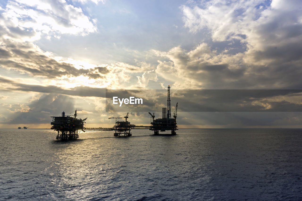 Silhouette of an oil production platform during sunset at offshore terengganu oil field