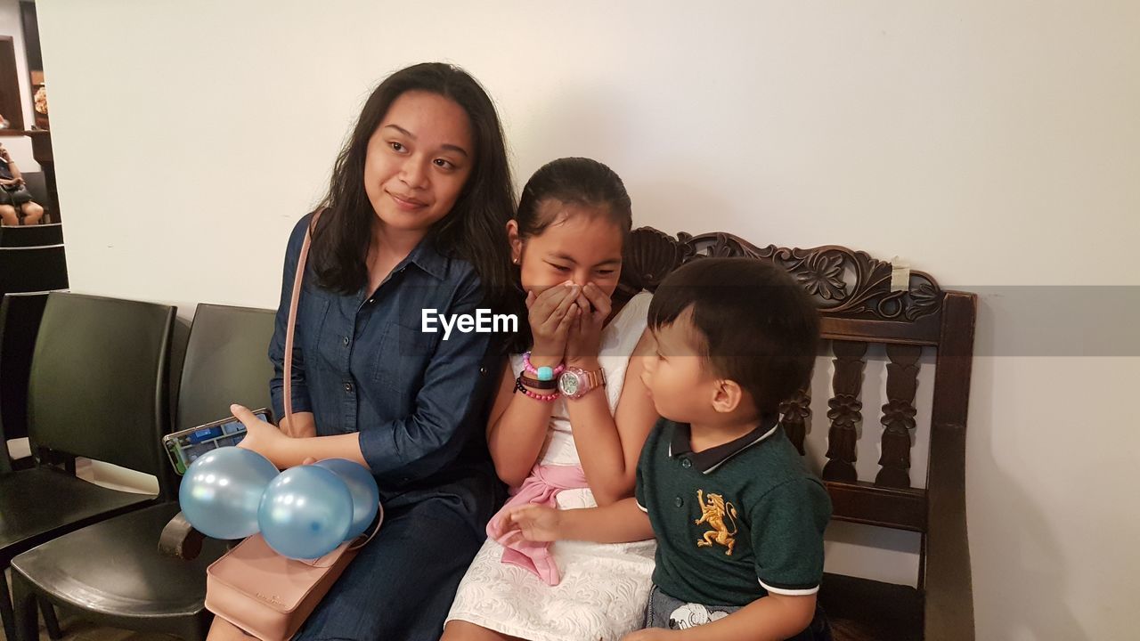 Siblings and woman at home